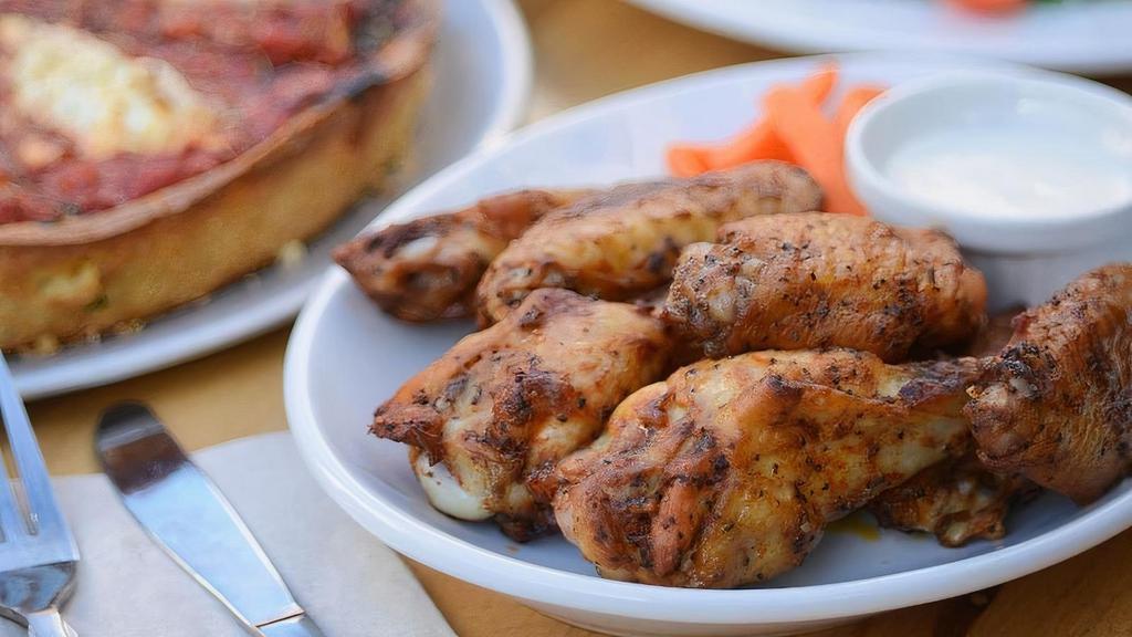 Spicy Chicken Wings · A pound of wings served with baby carrots and a creamy blue cheese
