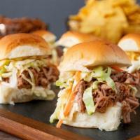 Pulled Pork Sliders · House marinated pulled pork, BBQ sauce and cheddar cheese on King's Hawaiian rolls. Served w...