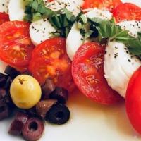 Caprese Salad · Fresh mozzarella served with sliced tomatoes, fresh basil, drizzled with extra virgin olive ...