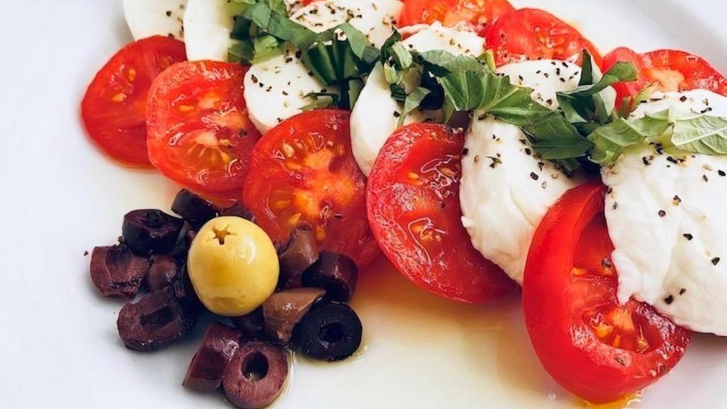 Caprese Salad · Fresh mozzarella served with sliced tomatoes, fresh basil, drizzled with extra virgin olive oil and balsamic vinegar