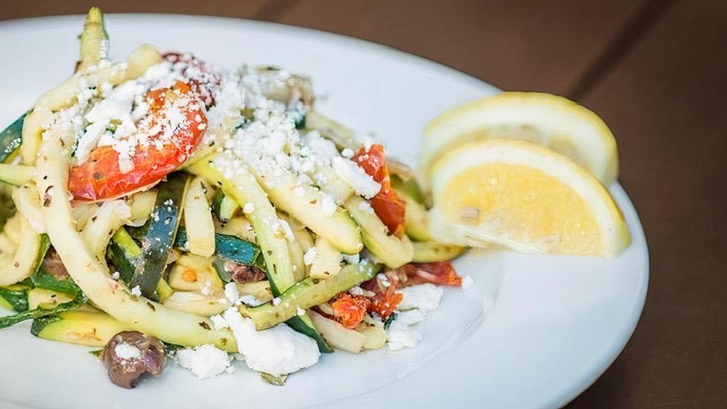Zoodle Salad · Seasoned ribbons of zucchini tossed with fire roasted tomatoes, artichoke hearts, Kalamata olives, topped with feta