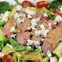 Steak House Salad · Strips of aged Angus flatiron steak, avocado, bleu cheese crumbles, tomatoes, cucumbers, red...