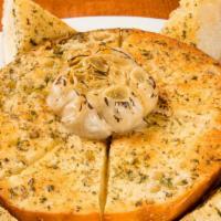 Ultimate Garlic Bread · A full round of sourdough bread smothered with our own herbed garlic butter and baked in hou...