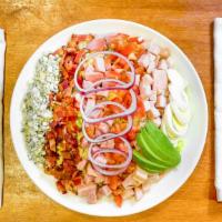 Cobb Salad · Iceberg lettuce, turkey, ham, tomatoes, avocado, bacon, crumbled blue cheese, red onion, and...