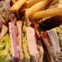 Downtown Club · A toasted trio of sourdough bread with lettuce, tomatoes, bacon, smoked turkey, ham, jack ch...