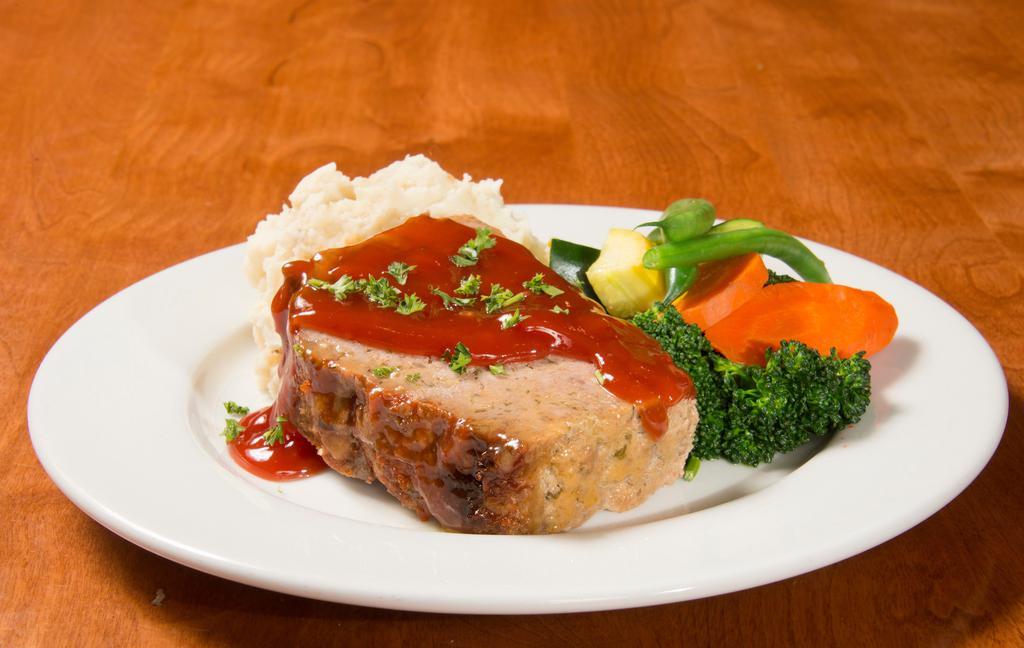 Mom's Meatloaf · House-made with 100% fresh Angus beef, sliced thick and topped with a sweet and tangy tomato glaze. Served with real garlic mashed potatoes and fresh vegetables.