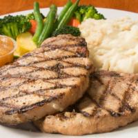 Pork Chops · Juicy center cut pork chops, served with real garlic mashed potatoes, fresh vegetables, and ...