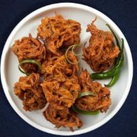 Onion Pakora · Assorted vegetables dipped in a light batter and fried until golden brown.