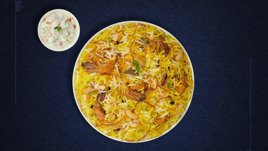 Prawns Biryani · Jumbo prawns cooked with biryani  spices and layered with basmati rice. Served with house raita.