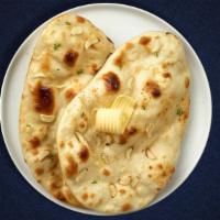 Chilli Naan · A rich, flat bread stuffed with serrano peppers and baked in the clay oven.