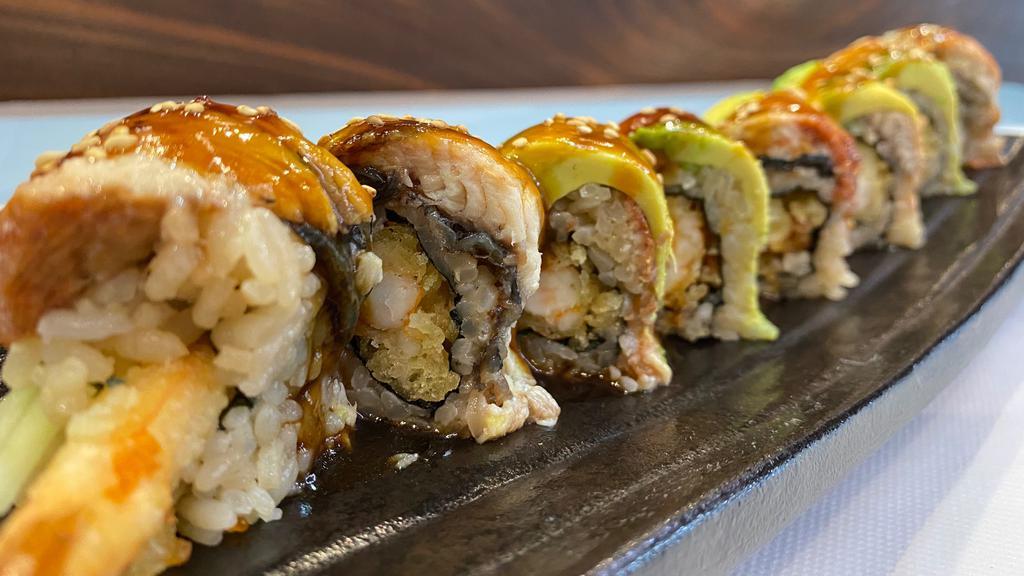 Dragon Roll · Shrimp tempura and cucumber inside. Unagi, avocado, sesame seeds, and unagi sauce on top.