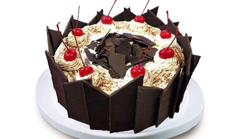 Black Forest · Layers of liqueur-moistened chocolate cake, brimming with maraschino cherries and cream, rich chocolate shavings and chocolate curls.