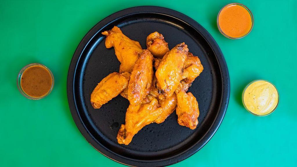 Bone In  · Bone In Chicken Wings tossed with your choice of flavor.