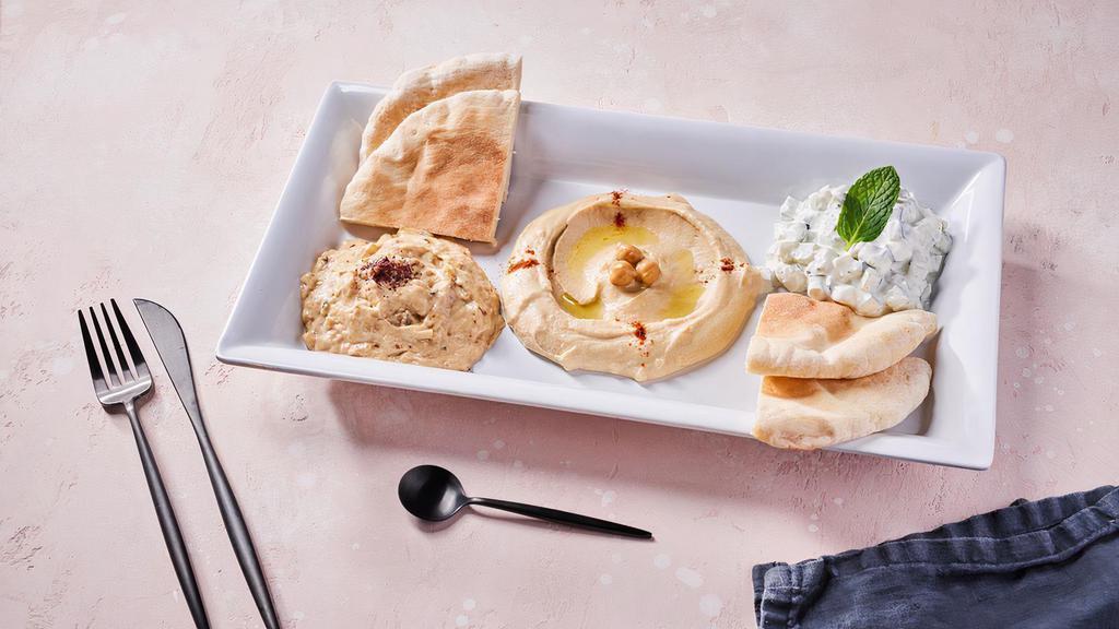 Mezze Platter (V) by SAJJ Mediterranean Express · By SAJJ Mediterranean Express. Pita bread with sides of hummus, babaganoush, and tzatziki. Contains gluten, dairy, soy, and nightshades. We cannot make substitutions.