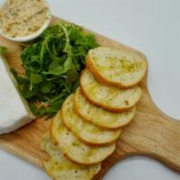 Sourdough Crostini and Brie · Toasted Sourdough Crostini Served with Spreadable Brie, Fresh Arugula and House Made Garlic ...