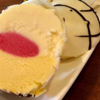 Mango & Passion Fruit Bomba · Mango, passion fruit and raspberry sorbetto all covered in white chocolate and drizzled with...