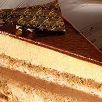 Opera Cake · Two layers of coffee mousse and two layers of
chocolate ganache. Decorated with chocolate
mi...