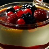 Creme Brulee with Frutti Di Bosco · A layer of raspberry sauce topped with a creamy custard and decorated with mixed berries coa...
