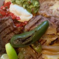 Carne Asada · Thin cut steak cooked to perfection with sautéed bell pepper and onion.