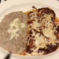 Ground Beef Enchiladas · With red chili sauce.