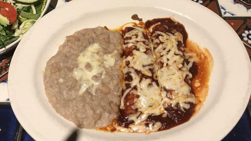 Ground Beef Enchiladas · With red chili sauce.