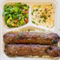 3. Goat Kebabs Plate · Two skewers of ground beef kebab,Hummus, salad and rice