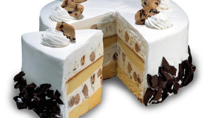 Cookie Dough Delirium™  - Ready For Pick Up Now · Layers of moist Yellow Cake and Sweet Cream Ice Cream with Cookie Dough and Chocolate Shavings wrapped in fluffy White Frosting