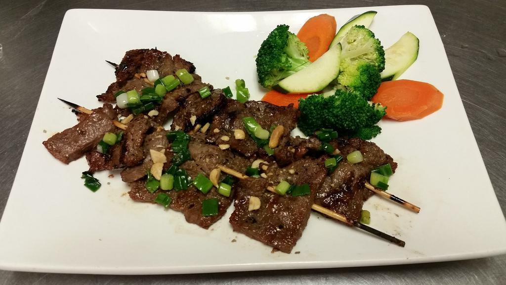 Grilled Lemongrass Beef · Marinated Angus sirloin flap beef topped with lemongrass, and options steam vegetable and roasted peanut.