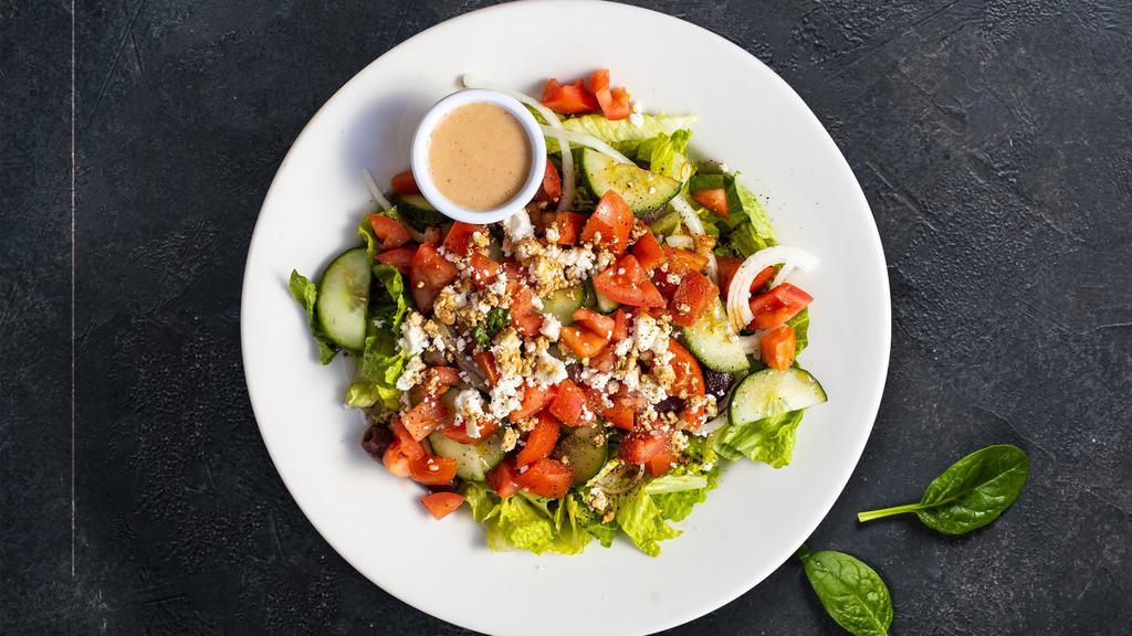 Greek Salad · Romaine lettuce, organic greens, Kalamata olives, Roma tomatoes, red onions, cucumbers, bell peppers and Feta cheese served with our homemade creamy Greek dressing.
