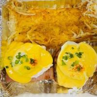 Eggs Benedict · English muffins topped with thick ham, poached eggs, green onions, smothered in hollandaise ...