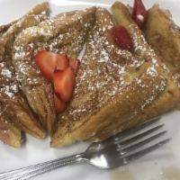 Cinnamon French Toast · Thick sliced French toast grilled to a golden brown. Served with whipped butter and syrup.