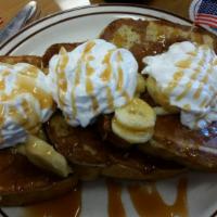Banana Caramel French Toast · Topped with whipped cream and syrup on the side.