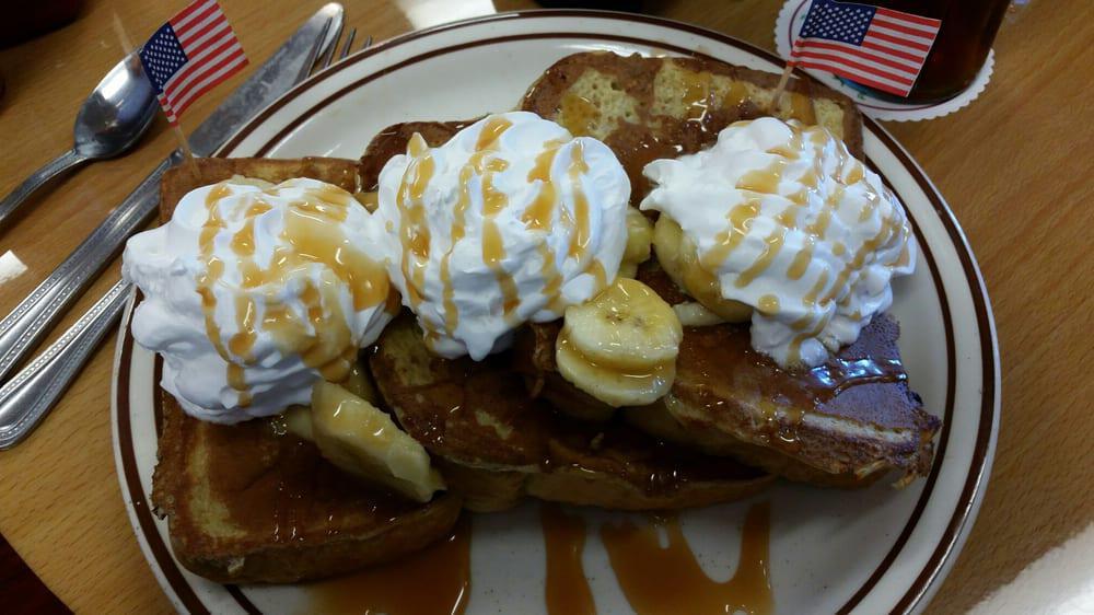 Banana Caramel French Toast · Topped with whipped cream and syrup on the side.