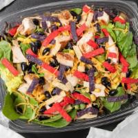 Southwest Chicken Salad · Grilled chicken, corn, black beans, cheddar cheese, greens, southwest dressing, tortilla str...