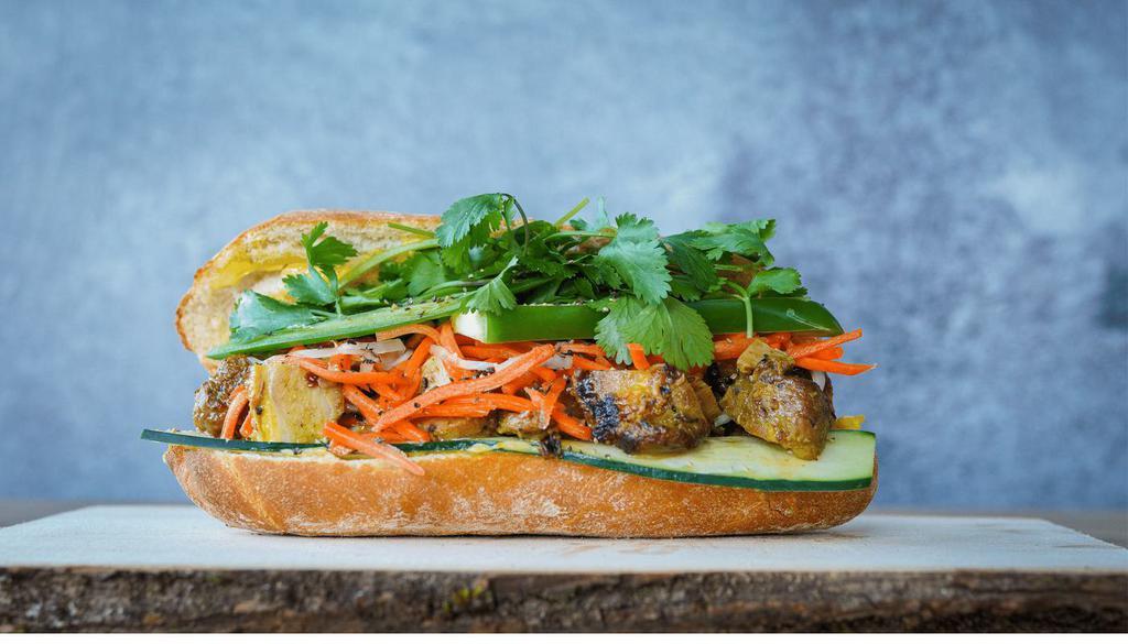 Chicken Banh Mi · Roasted lemongrass chicken with fried shallot mayo, pickled veggies, cilantro, cucumber, jalapeños, and maggi seasoning on a 8