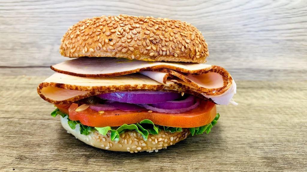 Turkey Breast Sandwich · Bagel with cold cut turkey breast. Comes with mayo, mustard, lettuce, tomato, onion, cucumbers, pickles, and pepperoncini.