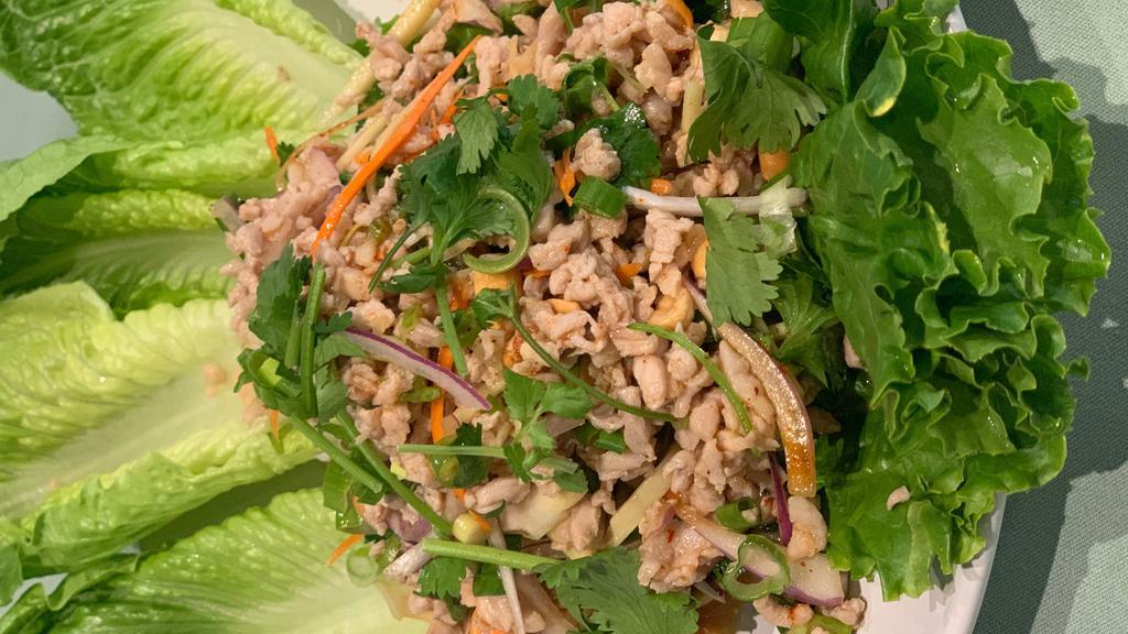 Thai Lettuce Wrap · Medium spicy. Minced chicken or tofu with ginger, peanut, chili, lime sauce, herbs, and spices with lettuce.
