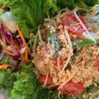 Green Papaya Salad (Som Tum) · Shredded green papaya, carrots, tomatoes, fresh green beans, and Thai chilies tossed in spic...