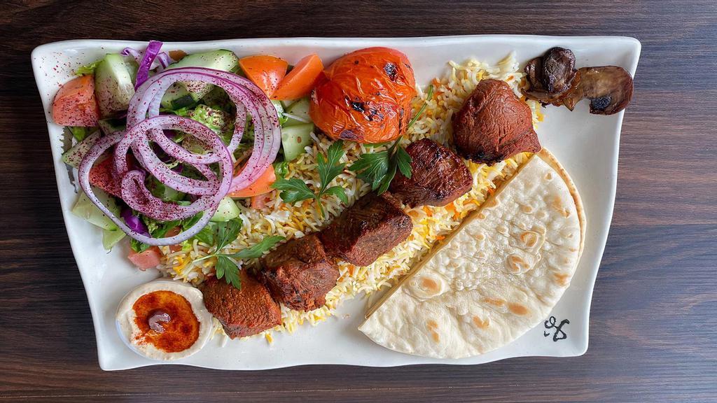 Lamb Kabab · Served with rice, salad, hummus, and pita.
