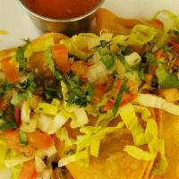 Tacos Dorados · 2 Crispy fold tortillas filled with potatoes & chorizo Top with tomato salsa, lettuce, pico ...