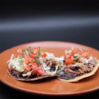 Tostadas · 2 Crispy flat tortillas, beans, lime pepper cabbage, salsa Mexicana. Choice of carnitas or t...