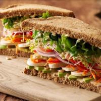 Farmer's Market · A garden sandwich on 9-grain bread piled high with avocado, sunflower seeds, sliced pickles,...