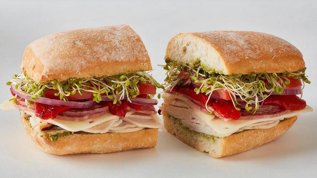 Ciao Down · Turkey, salami, Swiss, hot cherry peppers, onions, tomato, clover sprouts, basil pesto on a ciabatta roll.  Spicy.  830 cal.