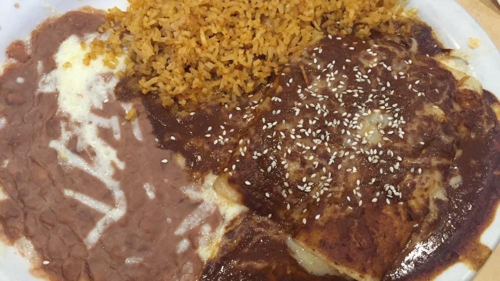 Mole Enchiladas · Two chicken enchiladas covered with melted jack cheese and mole sauce. Topped with raw onions, and sesame seeds.