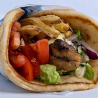 Chicken Souvlaki Pita · Seasoned chicken cubed and skewered on a stick, cooked over open flame and served on a warm ...