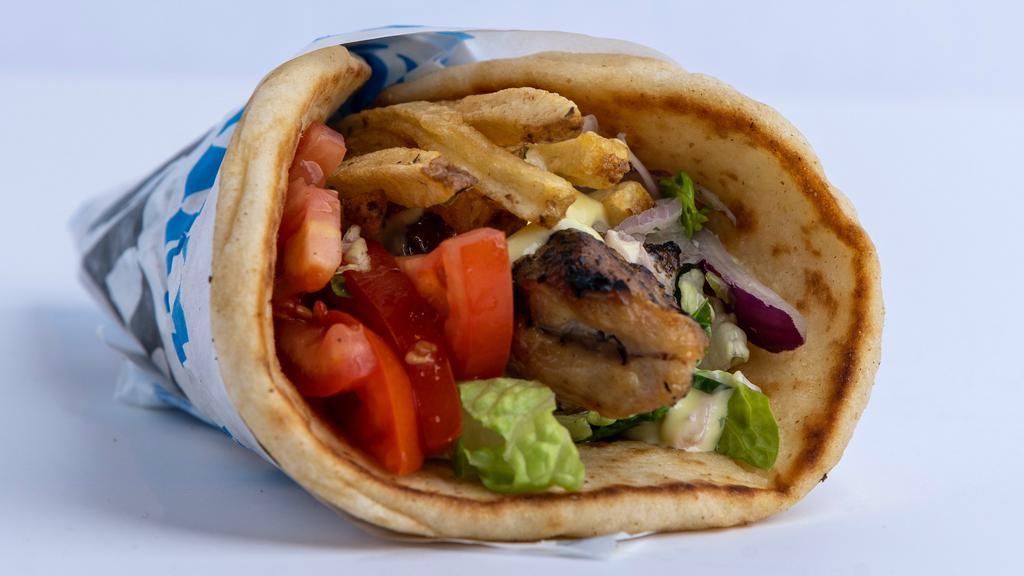 Chicken Souvlaki Pita · Seasoned chicken cubed and skewered on a stick, cooked over open flame and served on a warm pita bread filled with fries, tomatoes, onions, lettuce and mustard sauce.