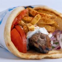 Pork Souvlaki Pita · Seasoned pork cubed and skewered on a stick, cooked over open flame and served on a warm pit...