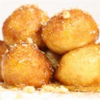 Loukoumades · Traditional Greek beignets, nuts and honey syrup.