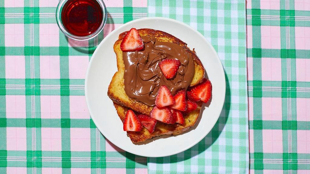 Le Nutella French Toast · So amazing, it belongs in the Louvre. Classic French toast slathered with gooey Nutella and strawberries with syrup on the side.