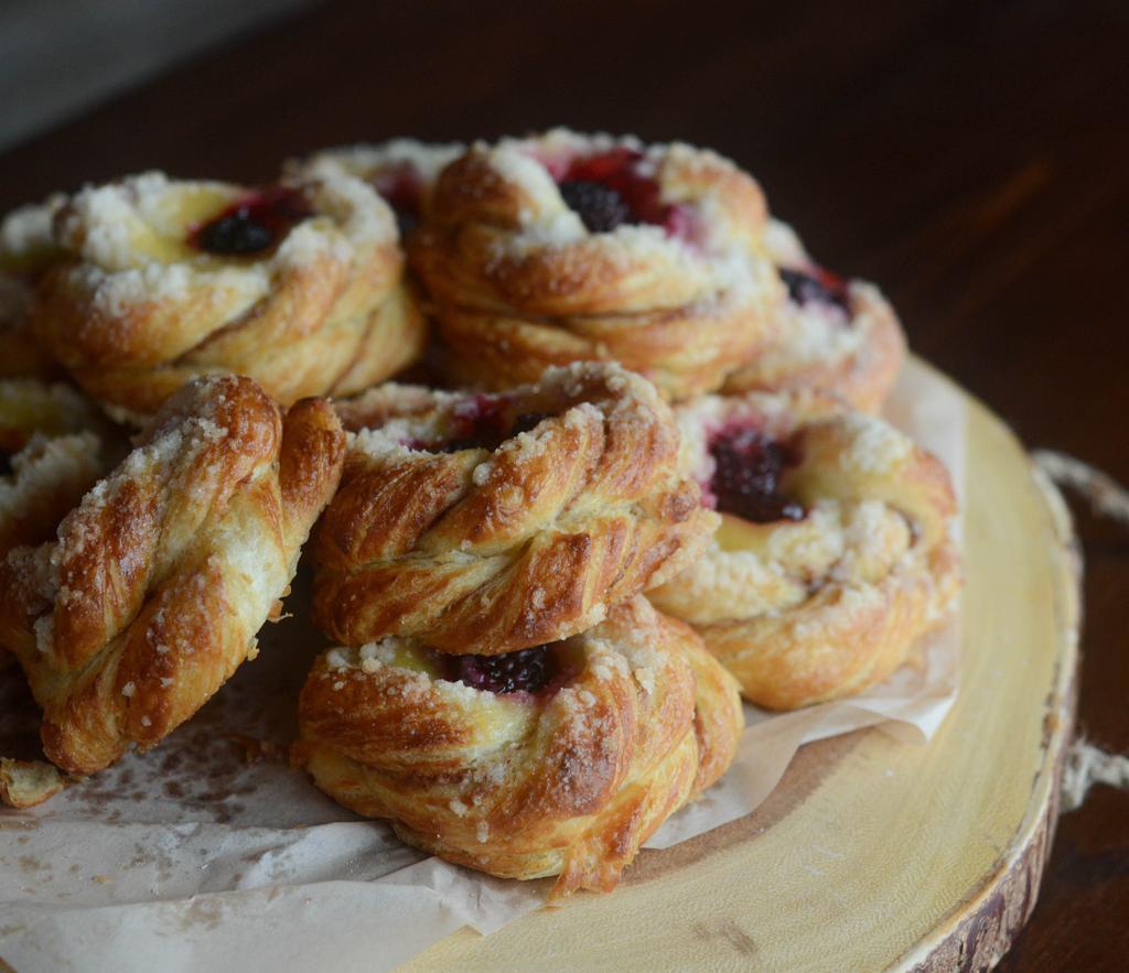 Blackberry Lemon Curd Danish · Light, crunchy bread with a thin layer of house-made Lemon curd with added blackberries and topped with powdered sugar.
